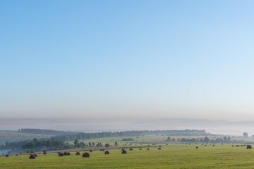 Fototapeta na wymiar panoramic view of green hills against blue sky on background 