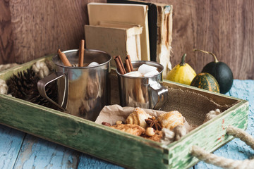 Metal mugs with cacao and marshmallows, still life