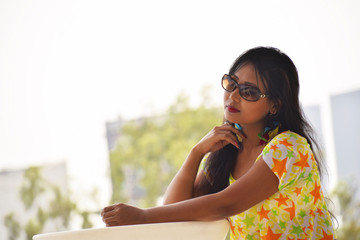 Indian girl sitting in a thoughtful pose, Pune