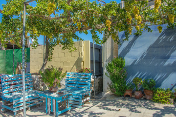 A rest corner made of simple boxes and painted blue in the city of Limasol in Cyprus. Outdoor corner for relaxing and drinking coffee on a sunny summer day.