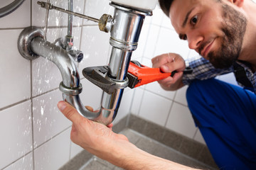Plumber Repairing Sink Pipe Leakage