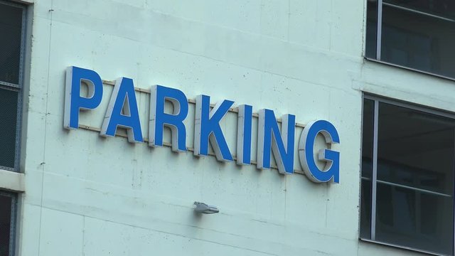 Closeup on a parking logo on a building wall