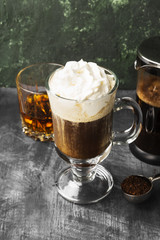 Irish coffee with whisky on dark background