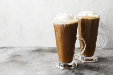 Ice coffee with ice cream on gray background. Copy space. Food background