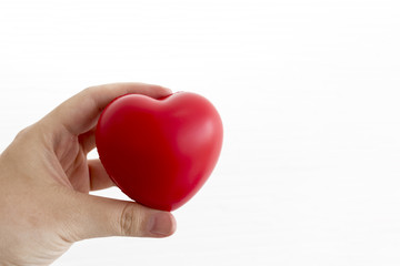 Fototapeta premium Hand holding red heart model on white background.Copy space.