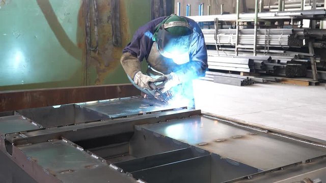 Welder working and soldering iron with mask