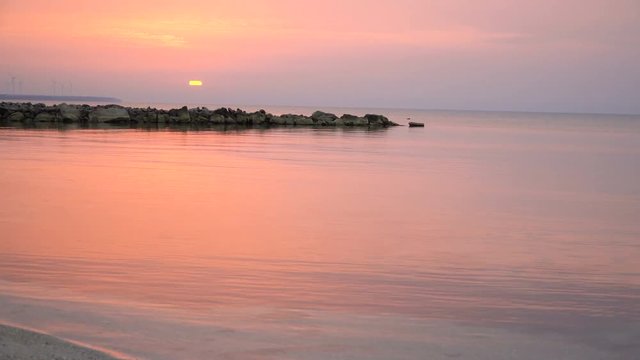 4K scenic red sunrise background sun rising. Close up video of sun rising behing sea