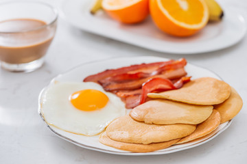 Healthy Full American Breakfast with Eggs Bacon and Pancakes