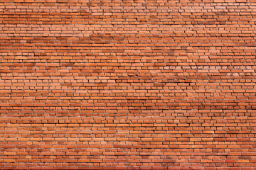 Red brick wall of an old building, background texture of a brick