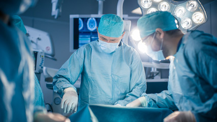Diverse Team of Professional surgeon, Assistants and Nurses Performing Invasive Surgery on a...