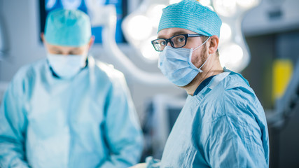 Portrait Shot of a Surgeon Looking into Camera. Diverse Team of Professional surgeons, Assistants...