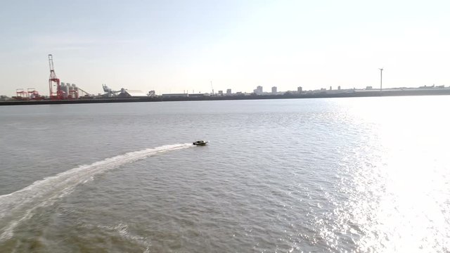 Drone follows speedboat on the River Mersey on a sunny summer morning