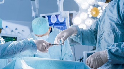 Close-up Shot in the Operating Room,  Assistant Hands out Instruments to Surgeons During Operation....
