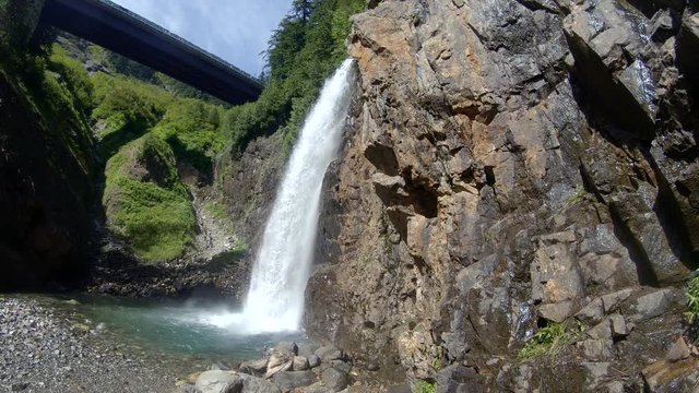 Reveal Waterfall Under Bridge in Pacific Northwest