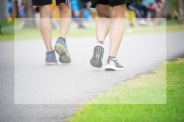 Fototapeta premium Running shoes and strong athletic legs jogging in health public park