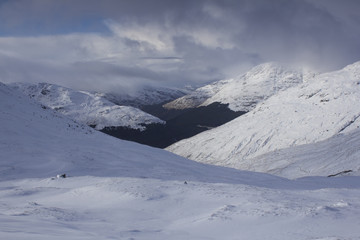 Fototapeta na wymiar A panoramic view of the snow caped Scottish Munro mountain in winter