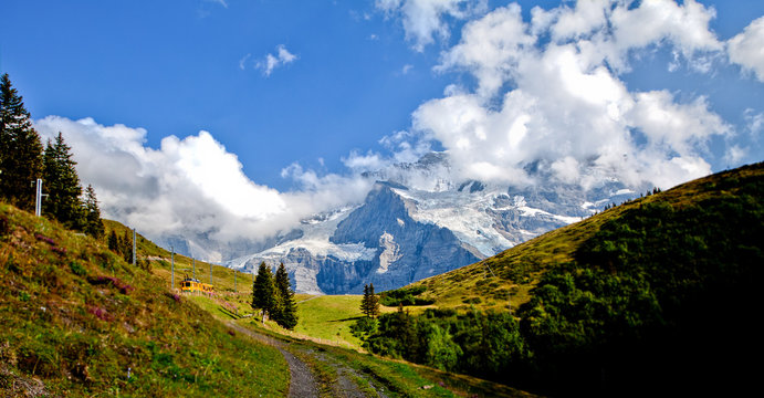 Swiss railway train across beautiful switzerland mountain nature