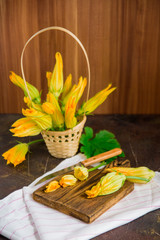 Edible flowers, zucchini blossoms on brown natural background