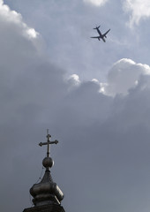 Airplane flying over church in Romania