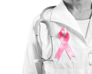 Doctor with pink ribbon on white background, closeup. Breast cancer awareness concept
