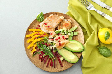 Plate with tasty avocado salad on table