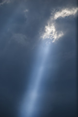 Fototapeta premium Ray of the sun through storm clouds