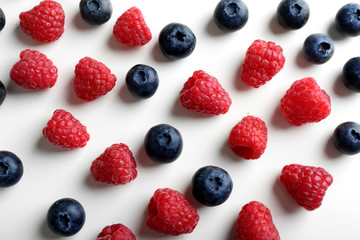Delicious ripe berries on white background, top view