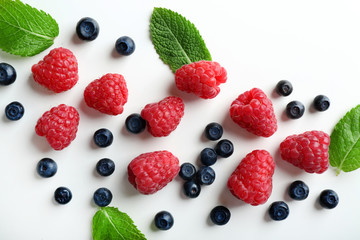 Delicious ripe berries on white background, top view