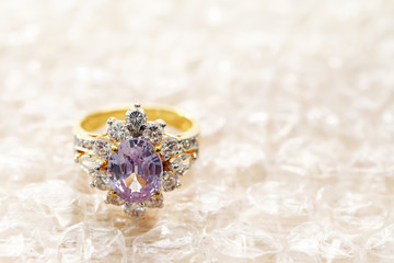 pink gemstone on diamond ring