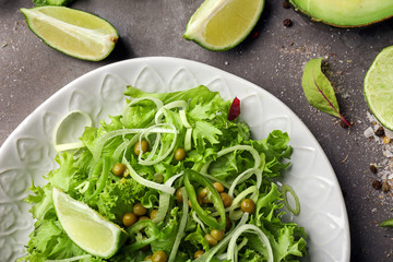 Plate with healthy vegetable salad on table