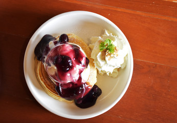 Blueberry cheese pancake with whipping cream.