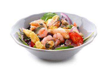 Bowl of delicious vegetable salad with seafood on white background