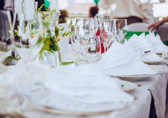Close-up of folded napkin and empty glasses