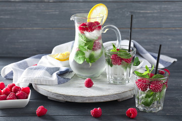 Composition with fresh raspberry mojito on wooden table