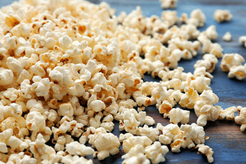 Delicious popcorn on wooden background, closeup