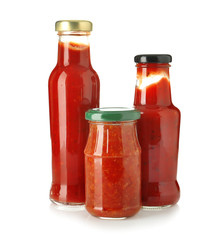 Glassware with tasty sauces on white background