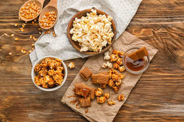 Composition with delicious popcorn on wooden background