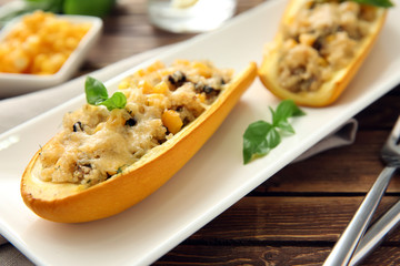 Quinoa stuffed zucchini boats on plate, closeup