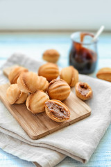 Delicious cookies with condensed milk on wooden board