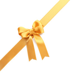 Fototapeta premium Golden ribbon with bow on white background