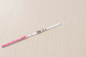 Positive pregnancy test result with two strips on the table. Two stripes on a test.