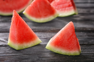 Sweet watermelon slices on wooden background
