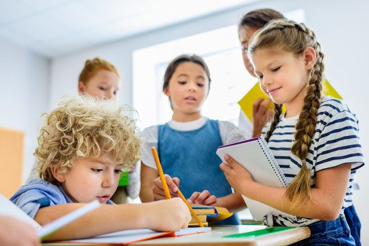pupils writing off homework of their classmate during break