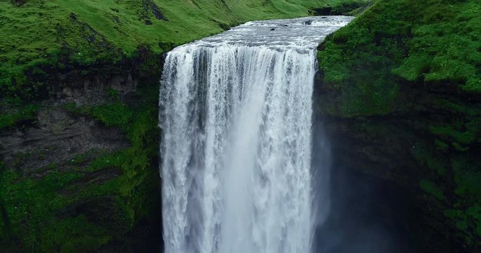 Aerial view close up of giant waterfall in Iceland filmed in slow motion