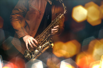 Jazz saxophone player in performance on the stage. color filter and hexagon bokeh added.
