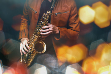 Jazz saxophone player in performance on the stage. color filter and hexagon bokeh added. - obrazy, fototapety, plakaty