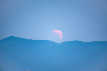 Lunar Eclipse, Moon rising behind a mountain