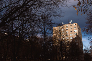 Old apartment building focusing with sunshine with dramatic sky in the morning