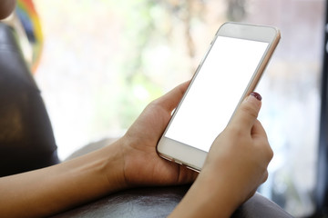 Close up hands holding mockup mobile smartphone with white screen.