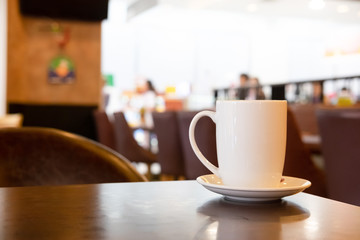 Mug of coffee on table with in cafe.